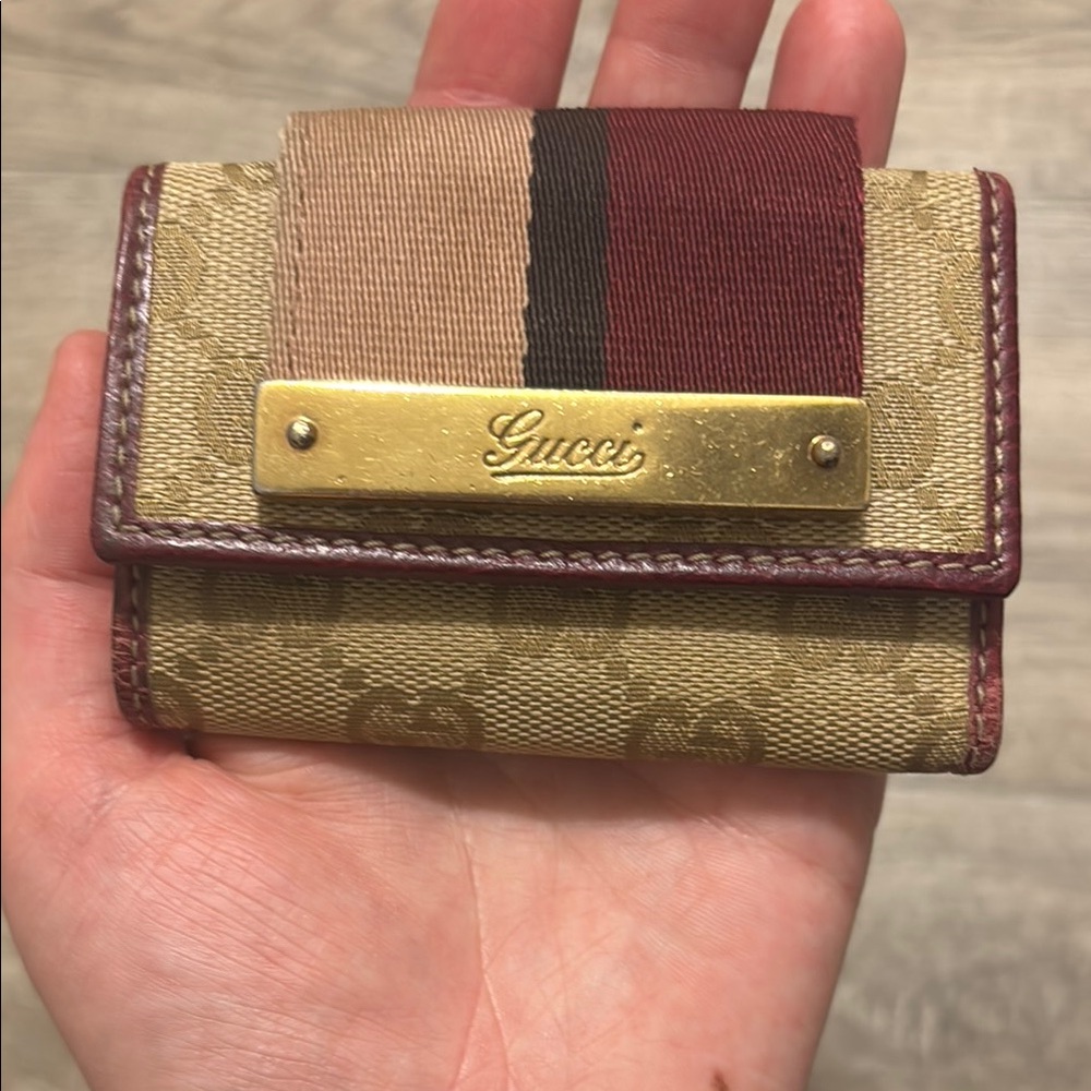 Gucci key ring holder two toned has two key rings has wear still good condition